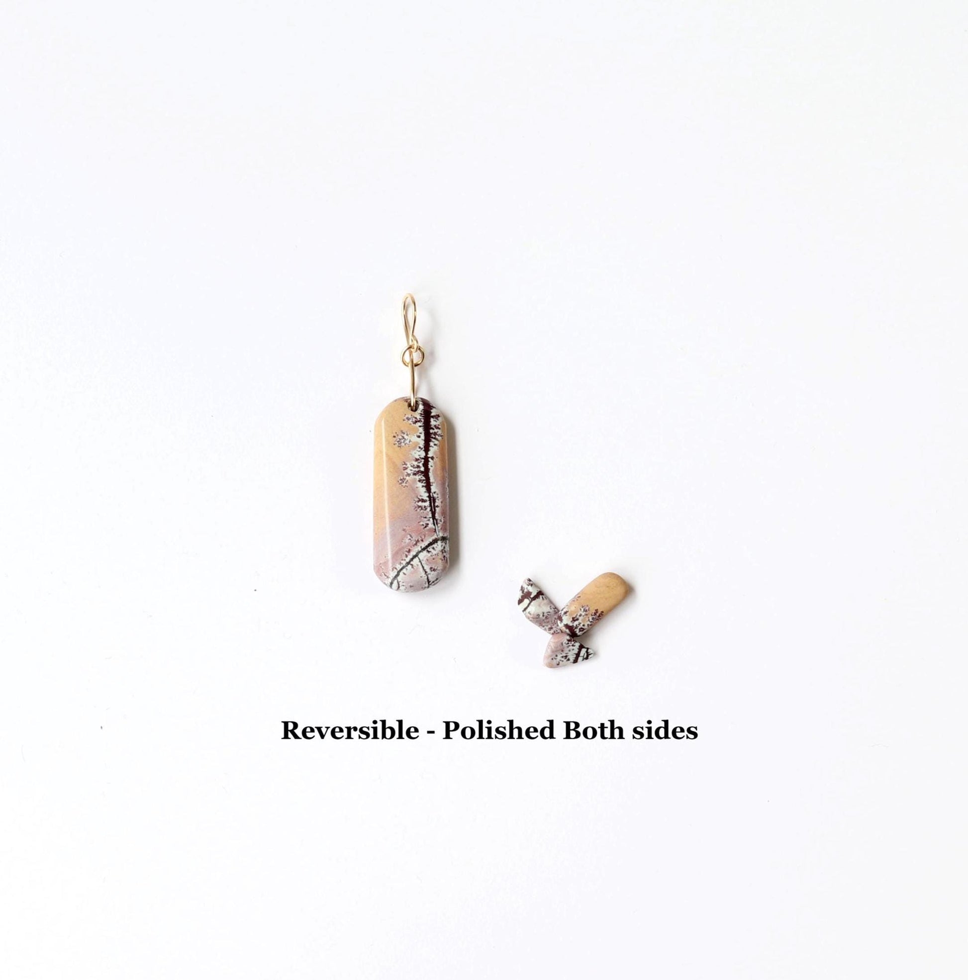 Sonora Dendritic reversible pendant polished on both sides shown on white background next to sonora dendritic chips for props.