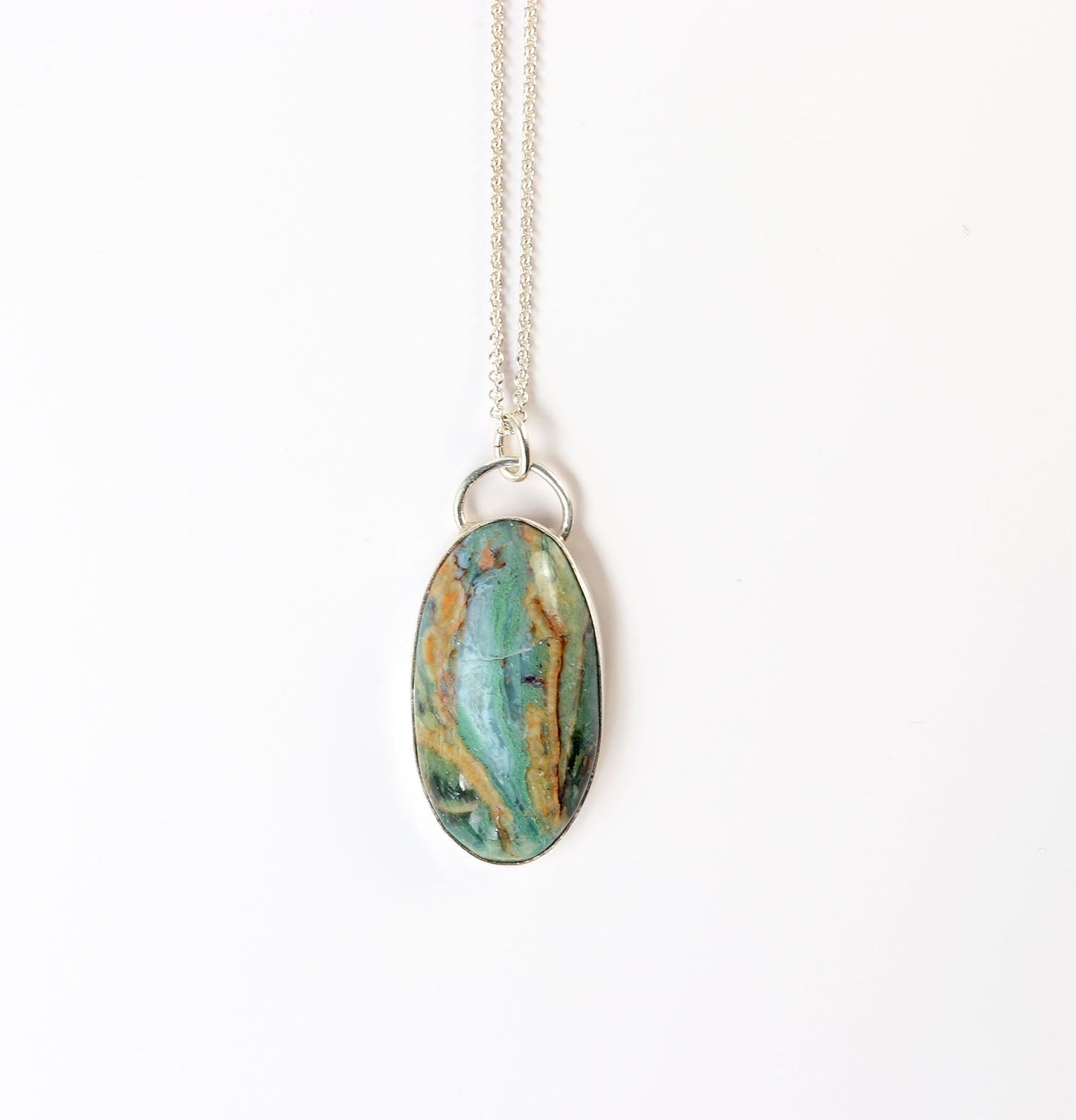 Sonoran Jasper with turquoise-green and desert brown natural patterns on a white background with necklace.