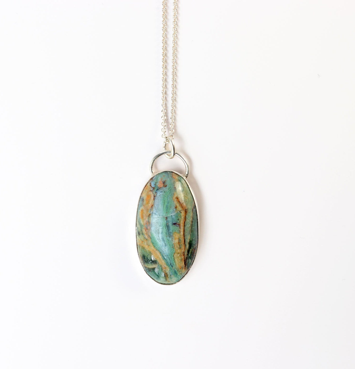 Sonoran Jasper with turquoise-green and desert brown natural patterns on a white background with necklace.