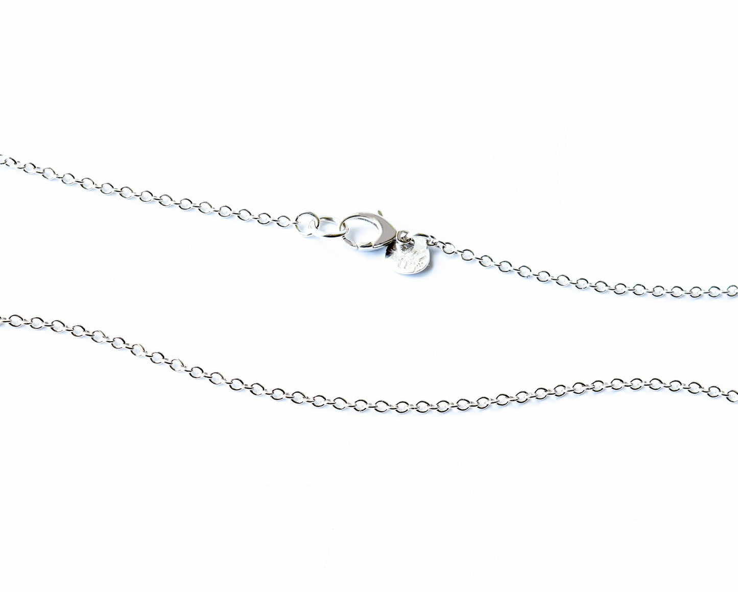 Argentium Silver necklace section with a teardrop lobster clasp and hallmark tag on a white background