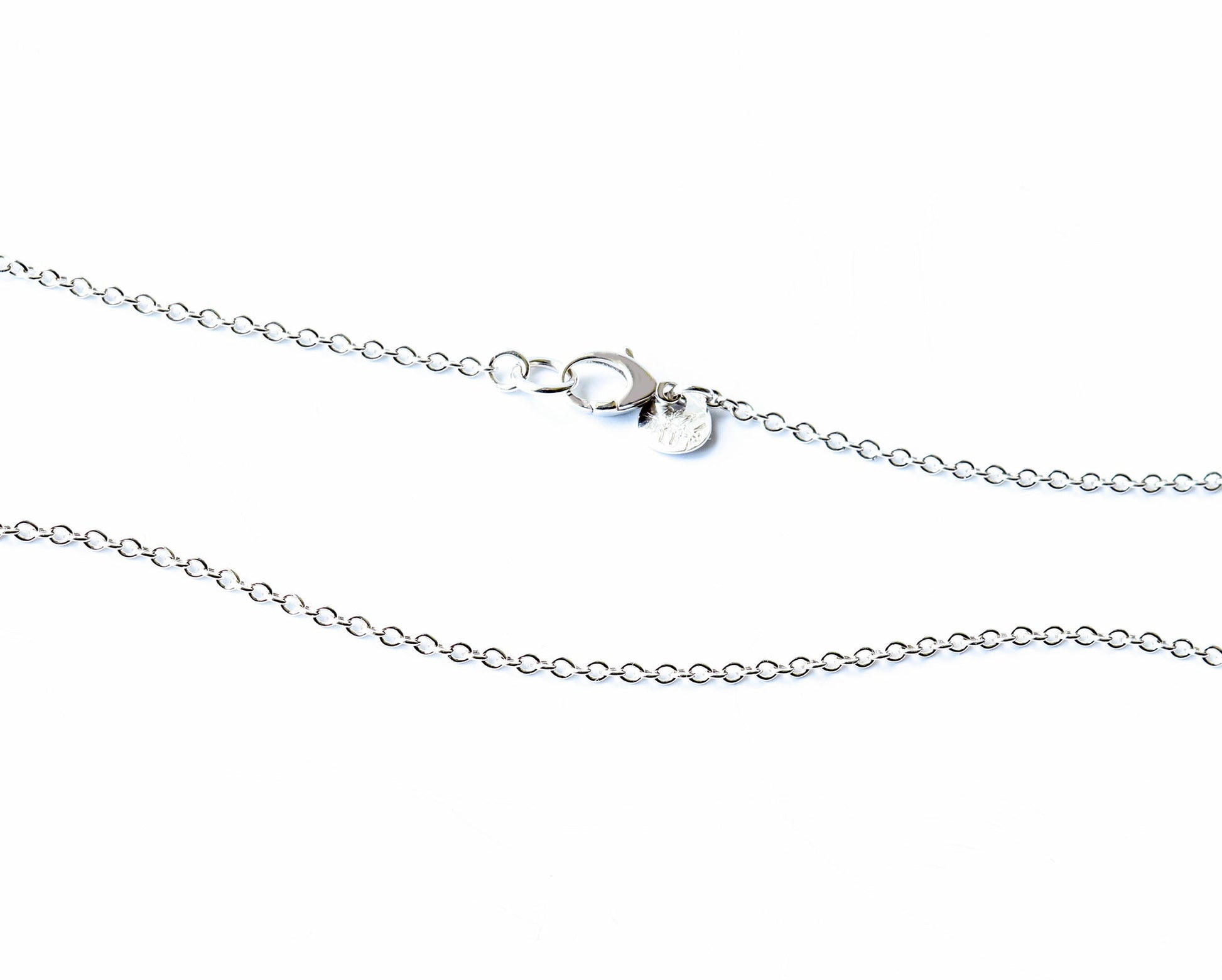 Argentium Silver necklace section with a teardrop lobster clasp and hallmark tag on a white background