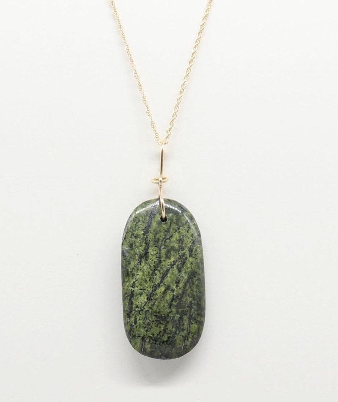 A Forest Green Jasper Pendant suspended from gold-filled rope chain necklace against light gray background.