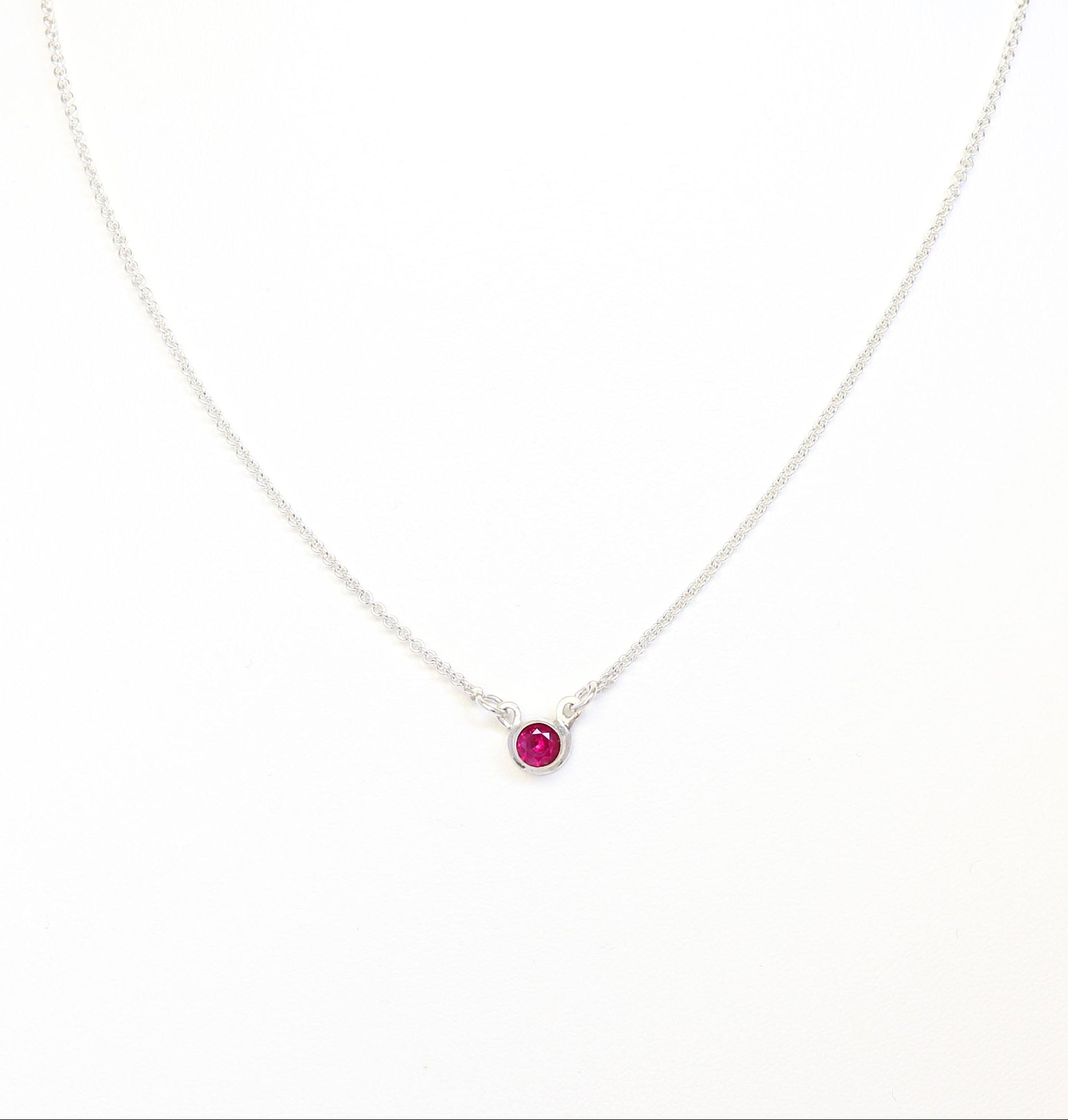 Argentium Necklace with a ruby red gemstone pendant on a white background