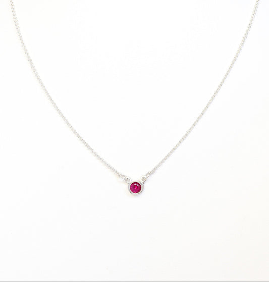 Argentium Necklace with a ruby red gemstone pendant on a white background