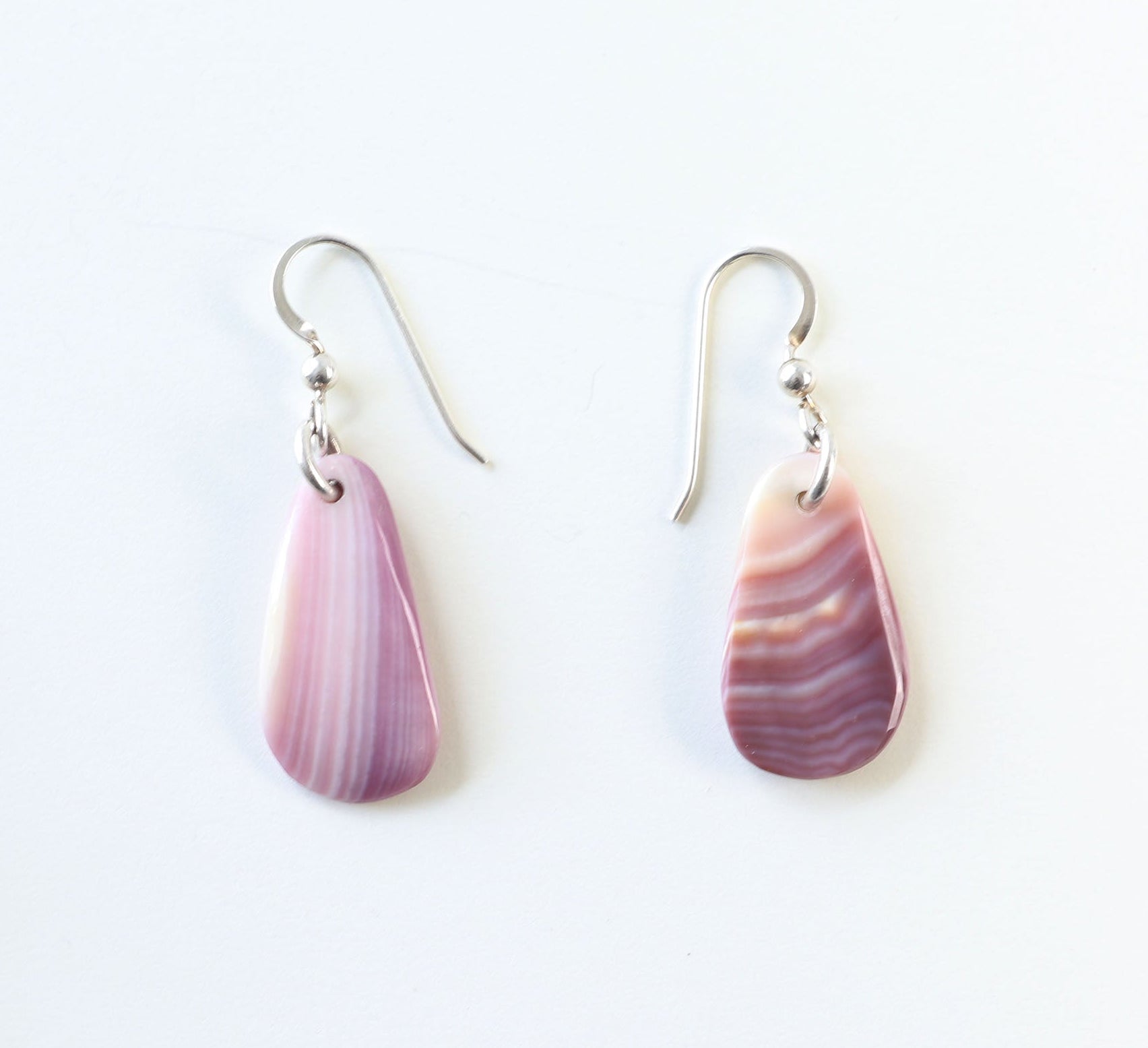 One-of-a-kind shell earrings handcrafted in our Missouri studio using natural Quahog shells—known for soft lavender and cream tones. 