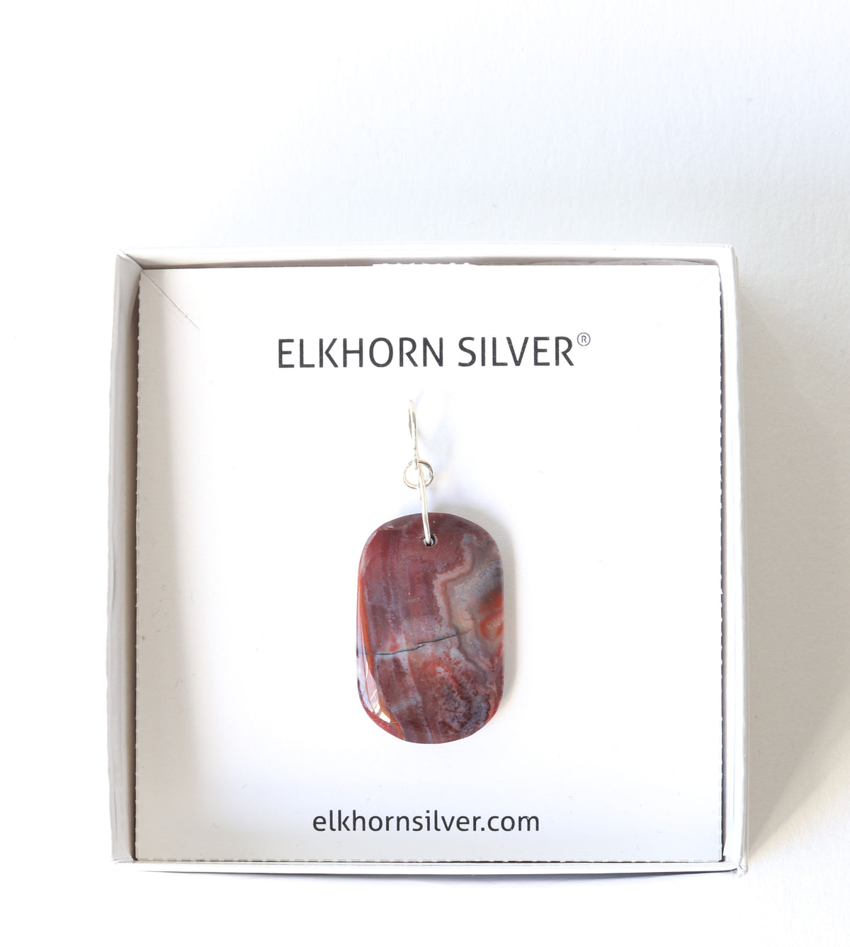 Custom Argentium silver bail handcut polished Red Mexican Agate pendant , presented in a white square box branded 'ELKHORN SILVER'.
