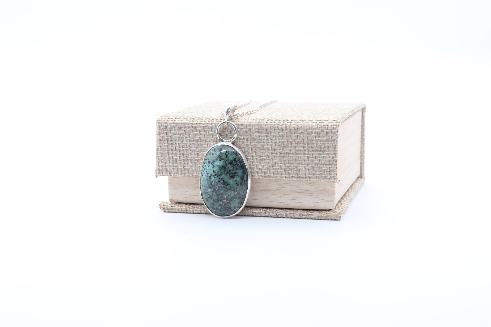 Necklace with a pendant on a white background shown with gift box.
