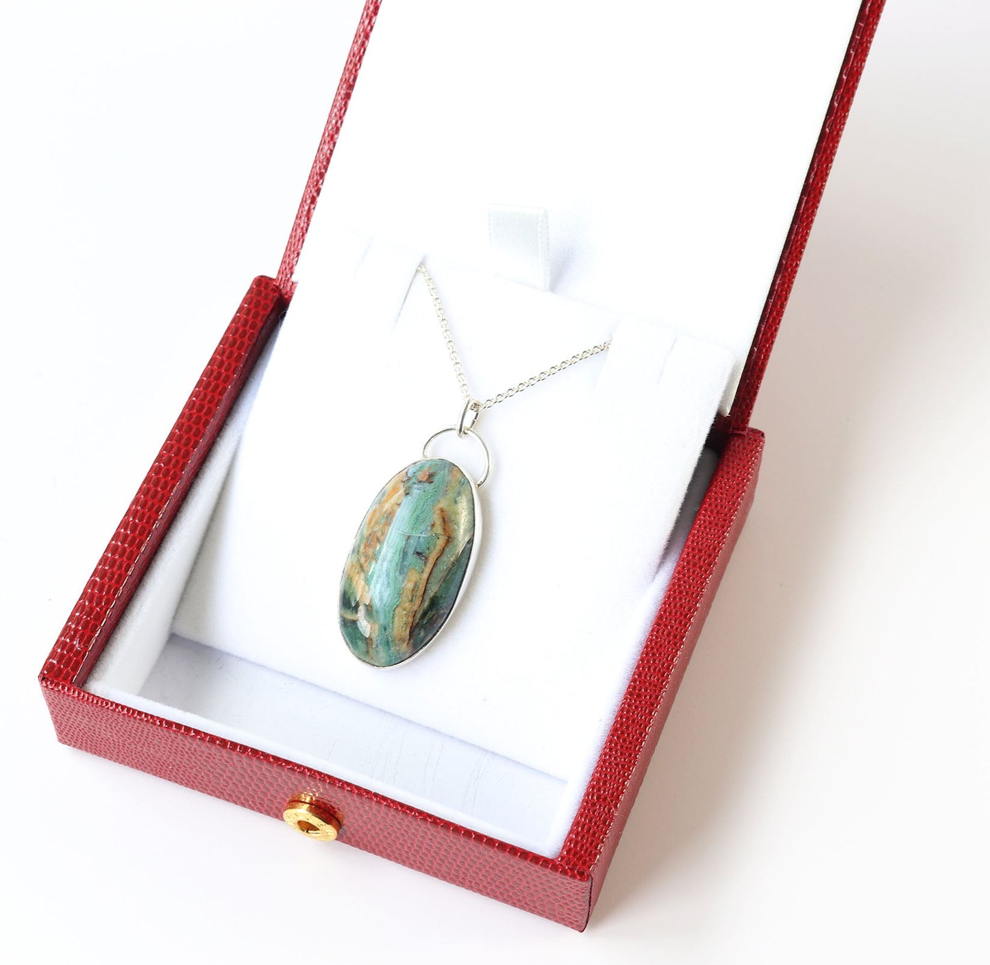 Necklace with a pendant in a red box on a white background
