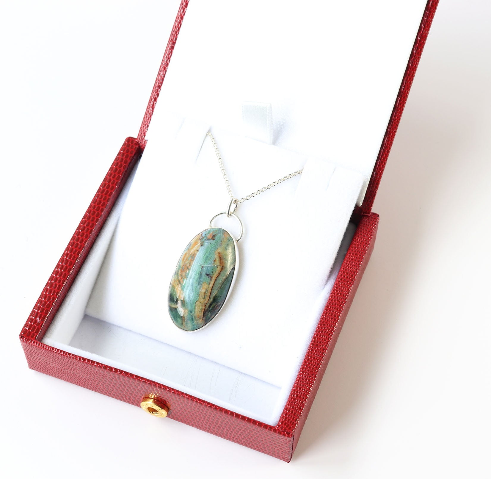 Necklace with a pendant in a red box on a white background