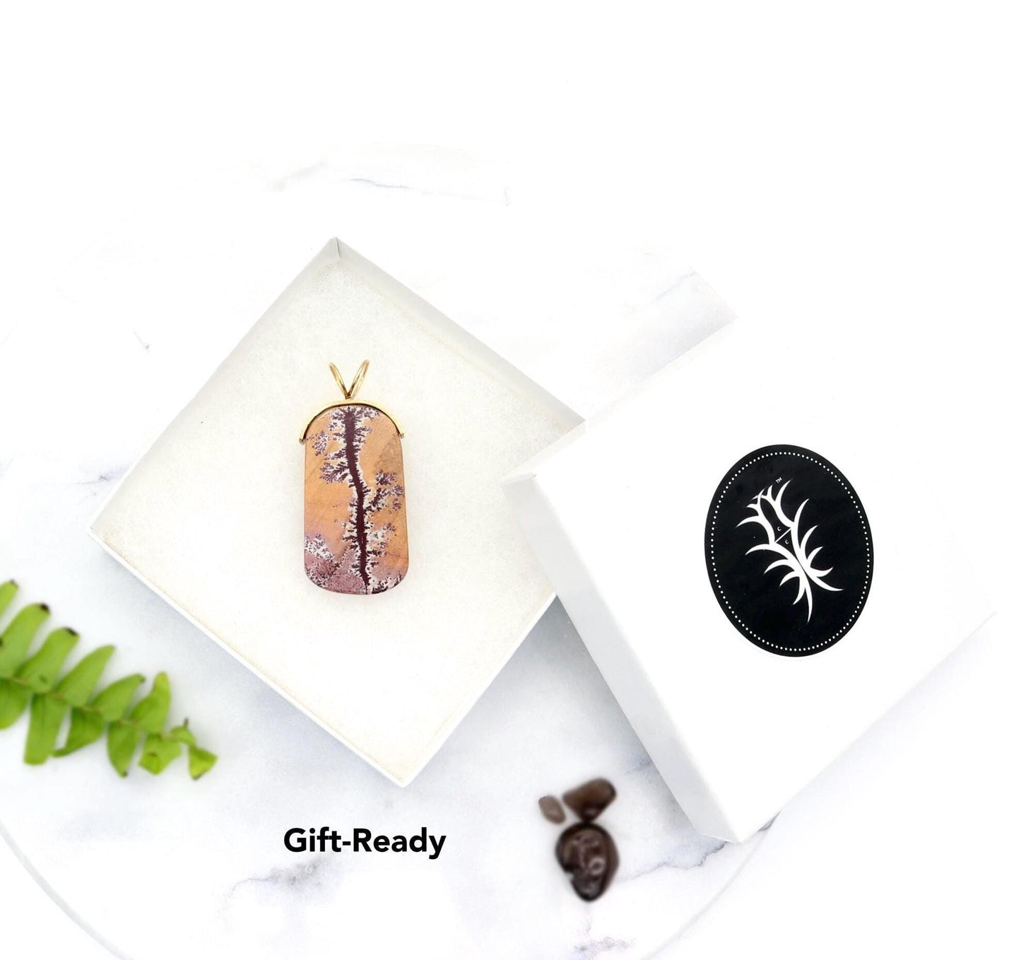 Pendant Arrives in a white gift-ready jewelry box shown against white marble background with pebbles and props not included.