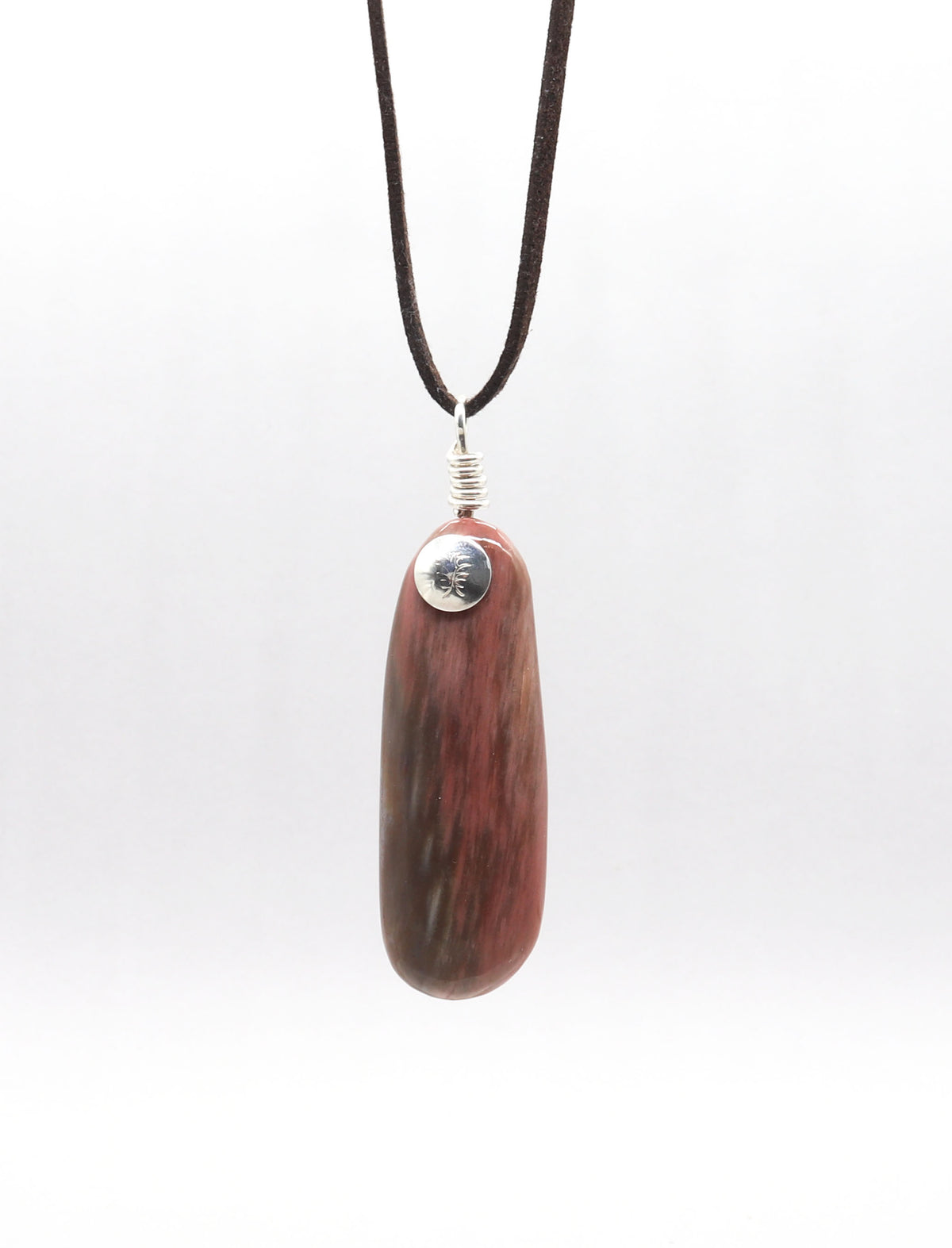A dark brown leather cord necklace featuring a polished reddish-brown Petrified Wood Pendant pendant with natural grain and a silver-colored metal cap.  Shown against a light gray background.