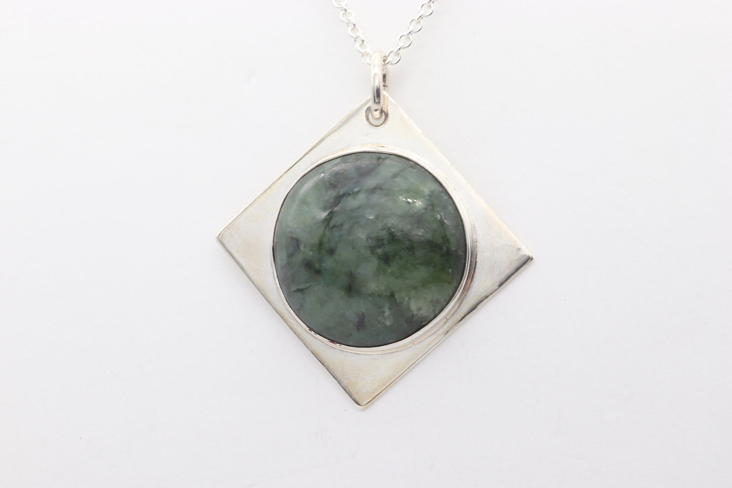 A handcrafted design from Elkhorn Silver™ that showcases a polished Wyoming Jade cabochon stone. This exceptional stone has been thoughtfully selected for its distinct coloring and composition, and it's encased in the finest Argentium® 935 Silver.