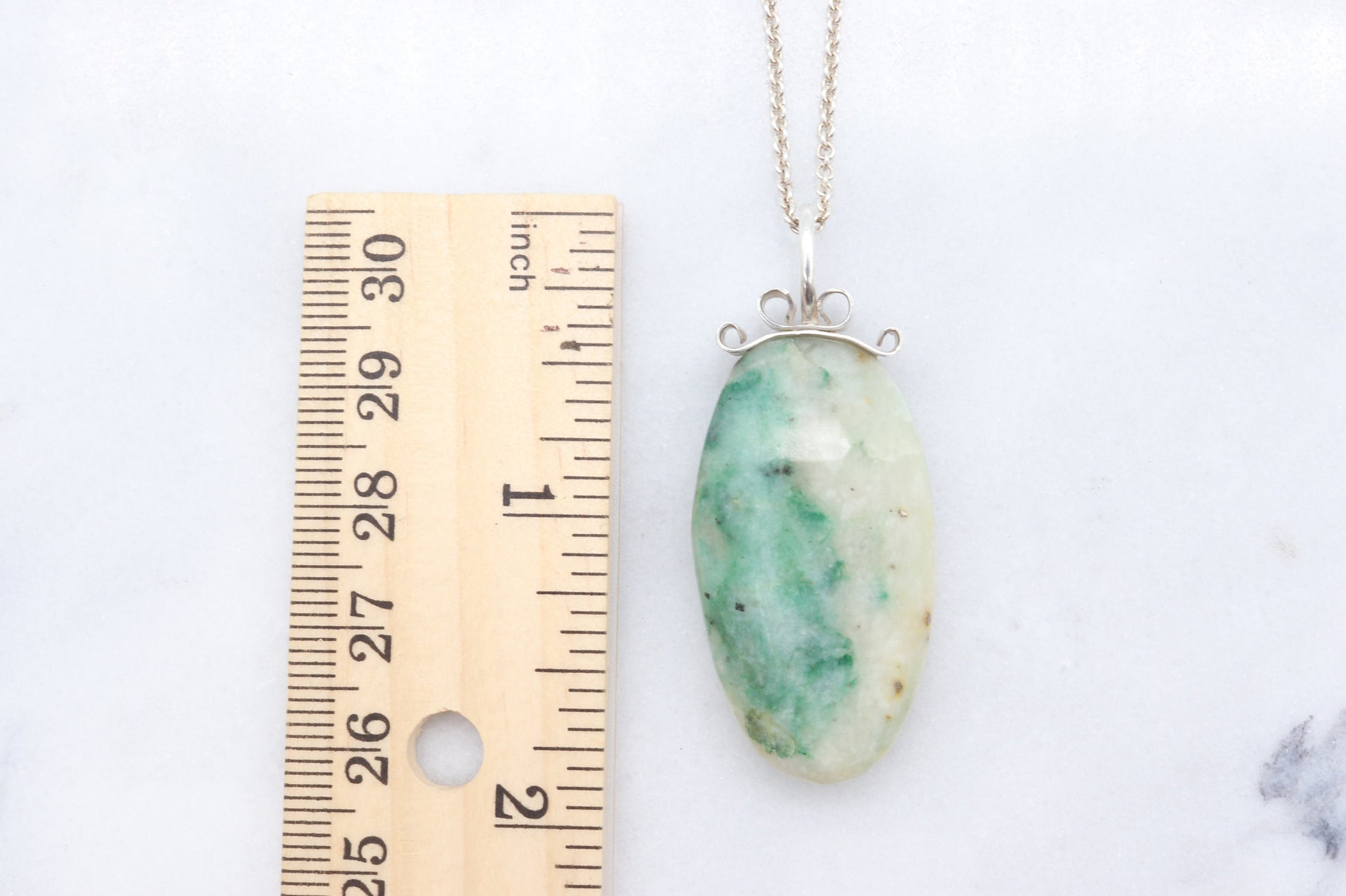 Lovingly handcrafted in our Missouri, USA studio is this natural 1.81 inch African Turquoise Jasper reversible pendant. Handcut and freeform polished to reveal the unique shades of green and cream hues crafted with a premium bow-shaped wire bail in sterling 935 Argentium silver plus a complementary sterling 935 Argentium chain ensuring both style and longevity.