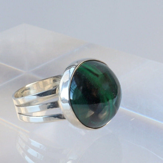 A handcrafted one-of-a-kind cabochon Malachite gemstone men's ring, handcut and polished in our Missouri studio. The ring is crafted from fine silver, and sterling Argentium® 935 Silver renowned for its resistance to tarnishing and its durable quality.