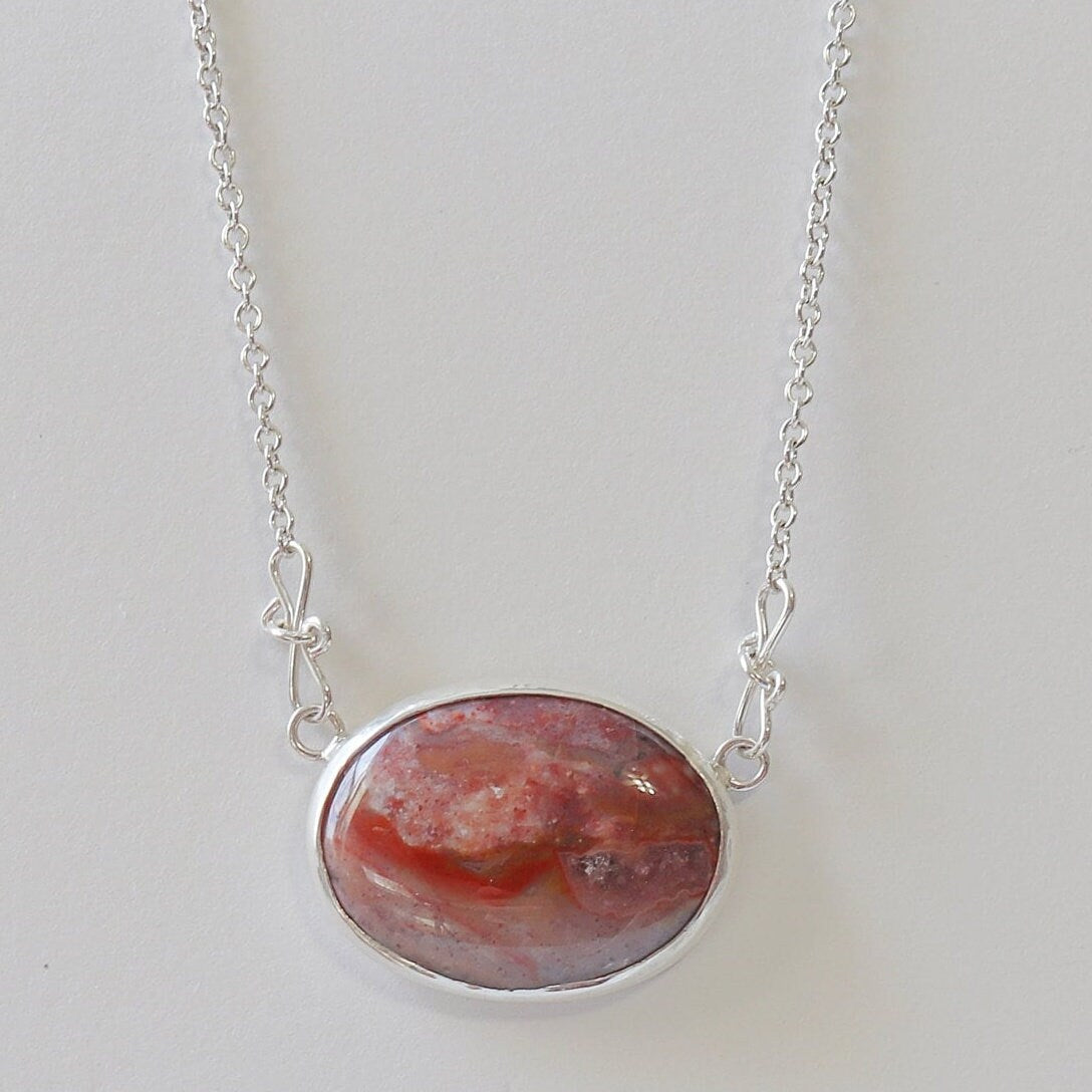 This unique Jasper gemstone was found in the Yellowstone River during a hike in Montana. It has been hand-cut and polished in our Missouri USA studio and set in a handcrafted solid sterling Argentium® 935 Silver bezel paired with an attached crafted custom chain with custom shepherd's hook clasp, resulting in a one-of-a-kind statement Necklace.