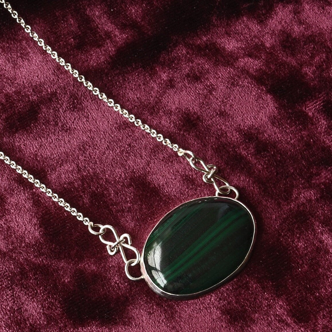 A unique Malachite gemstone pendant hand-cut and polished stone and set in solid sterling 935 Argentium® Silver. Designed with a custom chain and S hook for easy wearability.