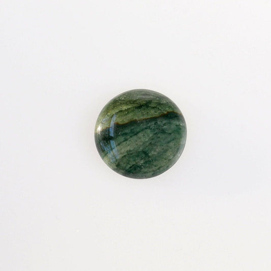Handcut and Polished this Arizona Green Lizard gemstone cabochon features a rich blend of deep green tones and earthy patterns. The stone is shaped and polished into a smooth cabochon shown on a white background.