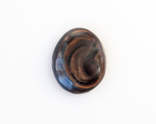 Hand-cut Mahogany Obsidian oval cabochon with reddish-brown and black swirling patterns shown against white background.