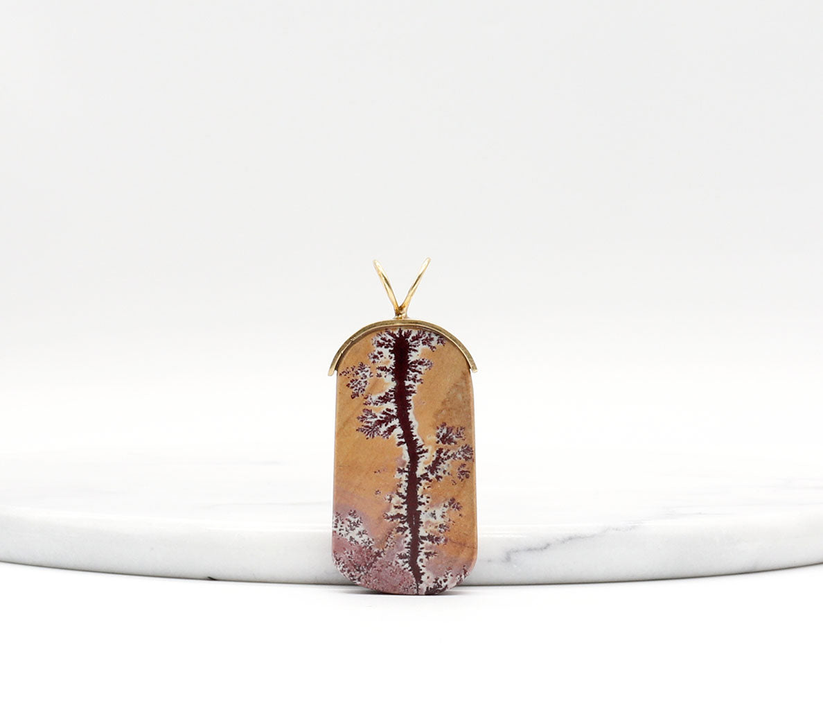 Sonoran Dendritic Rhyolite Pendant – Brass Bail shown against white marble with text overlay Dendritic Patterns - Tan Pink Charm shown on light gray background.
