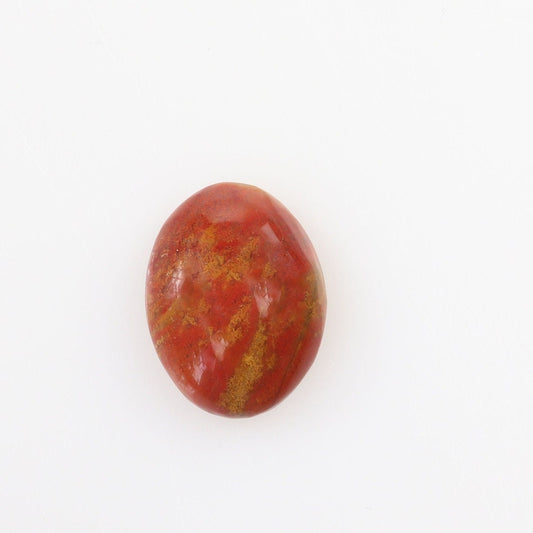  Sonoran Sunrise Chrysocolla Cuprite gemstone, handcut and polished into an oval shape cabochon, revealing its natural vibrant shades of warm reds and yellow, reminiscent of a desert sunrise.  Shown against white background.