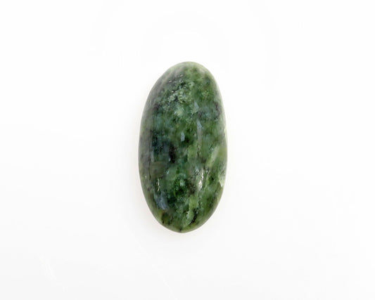 Hand-cut oval Wyoming Nephrite Jade cabochon with natural green tones and dark mineral patterning shown on plain white background.
