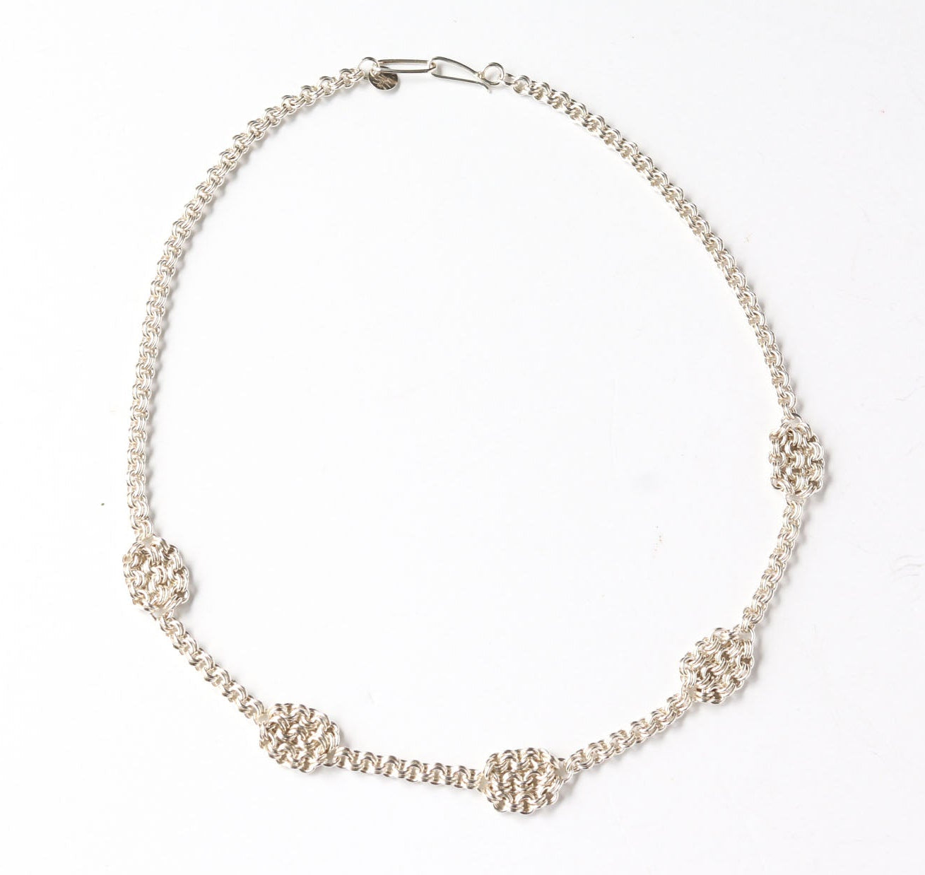 Argentium Silver necklace with woven accents on a white background