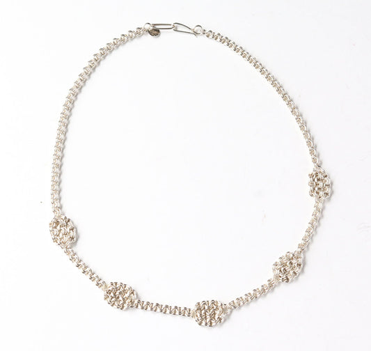 Argentium Silver necklace with woven accents on a white background