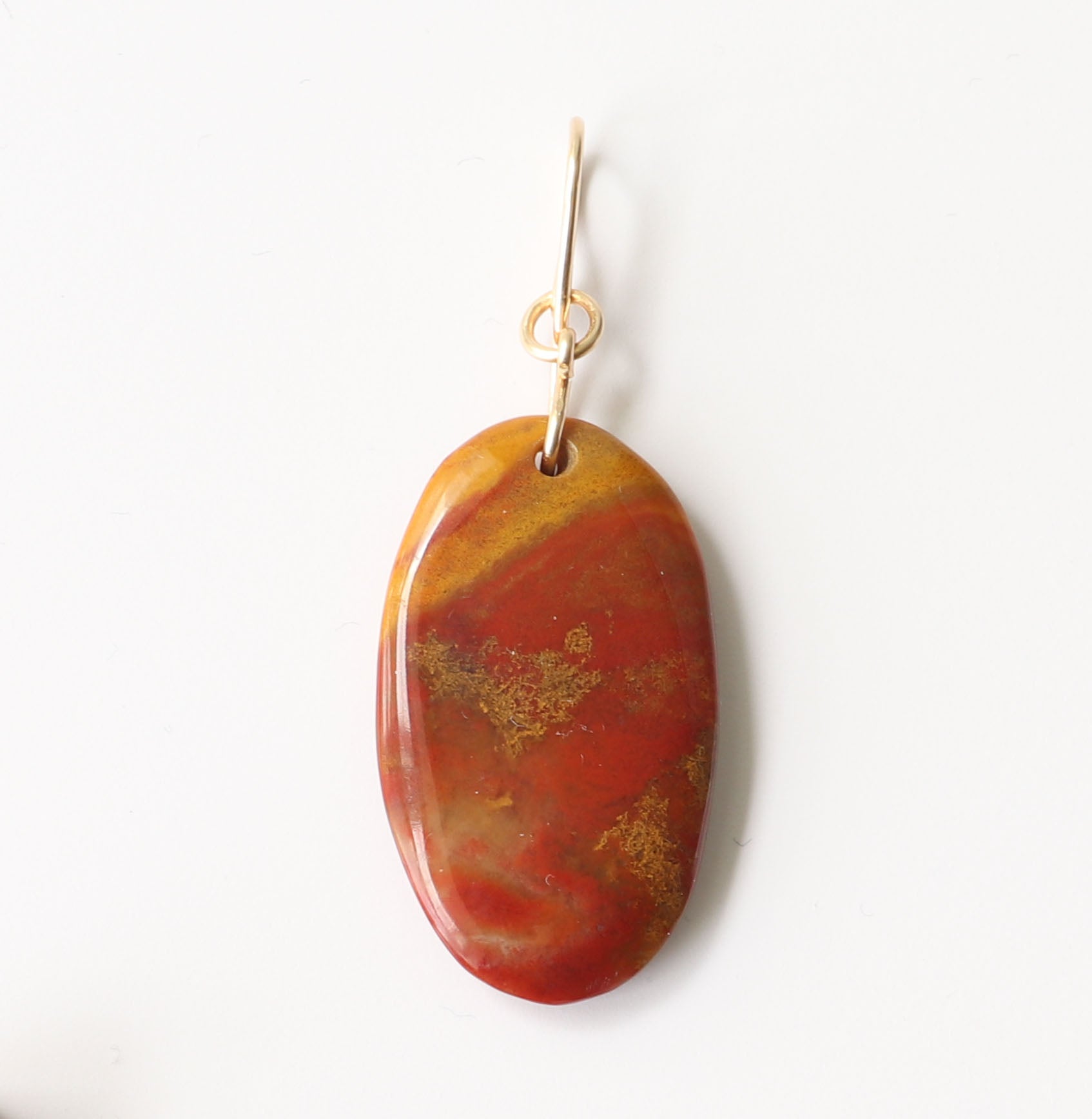 Closeup of Sonoran Sunrise  with a display of deep red cuprite, golden mustard, and sun-baked earthy hues—cut and polished by hand in our Missouri studio shown on white background.