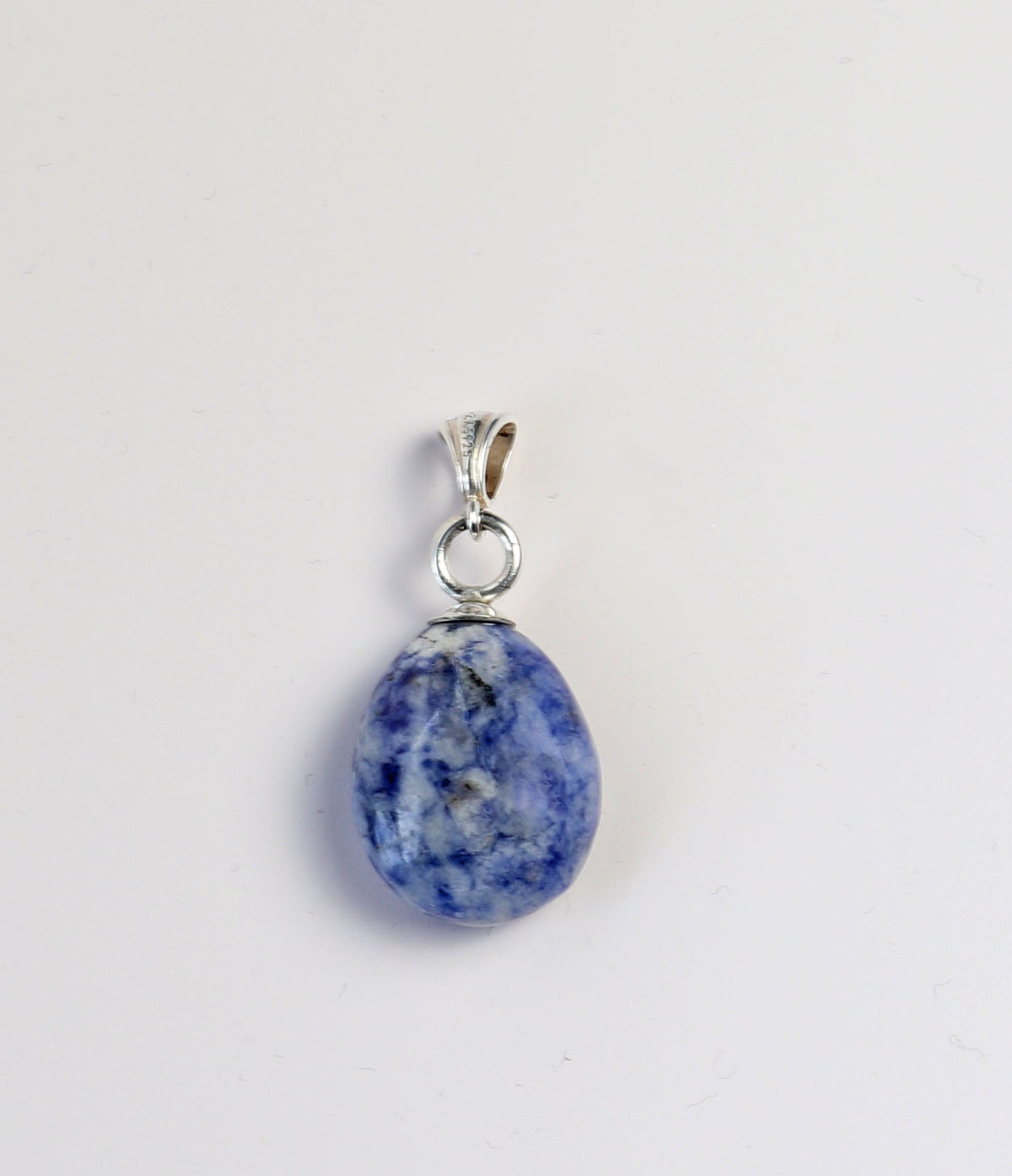 A teardrop-shaped blue sodalite stone pendant set silver bail, shown on a plain white background.