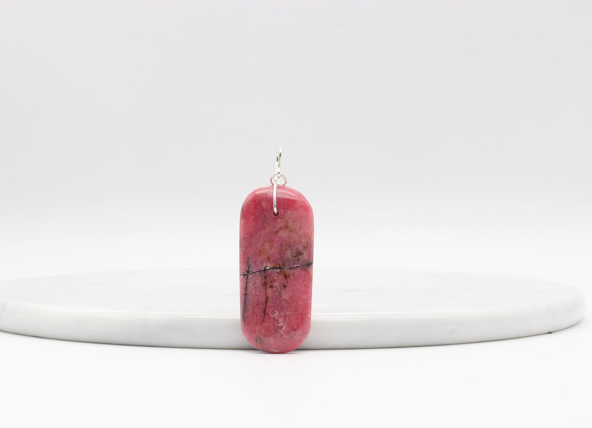 Natural Rhodonite pendant necklace with solid Argentium 935 Silver bail and chain shown on light gray background.