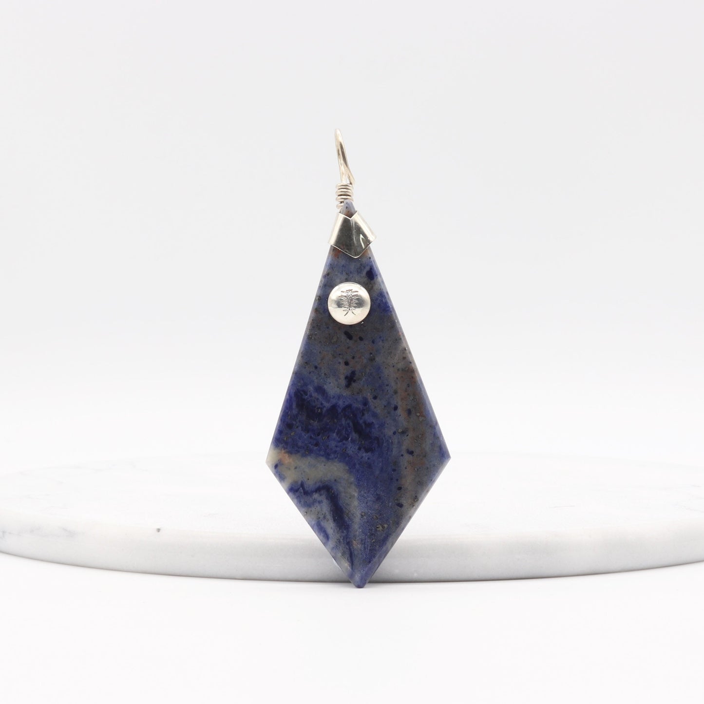 Blue Sodalite Pendant – Argentium® Silver Handmade on a white marble with a white background
