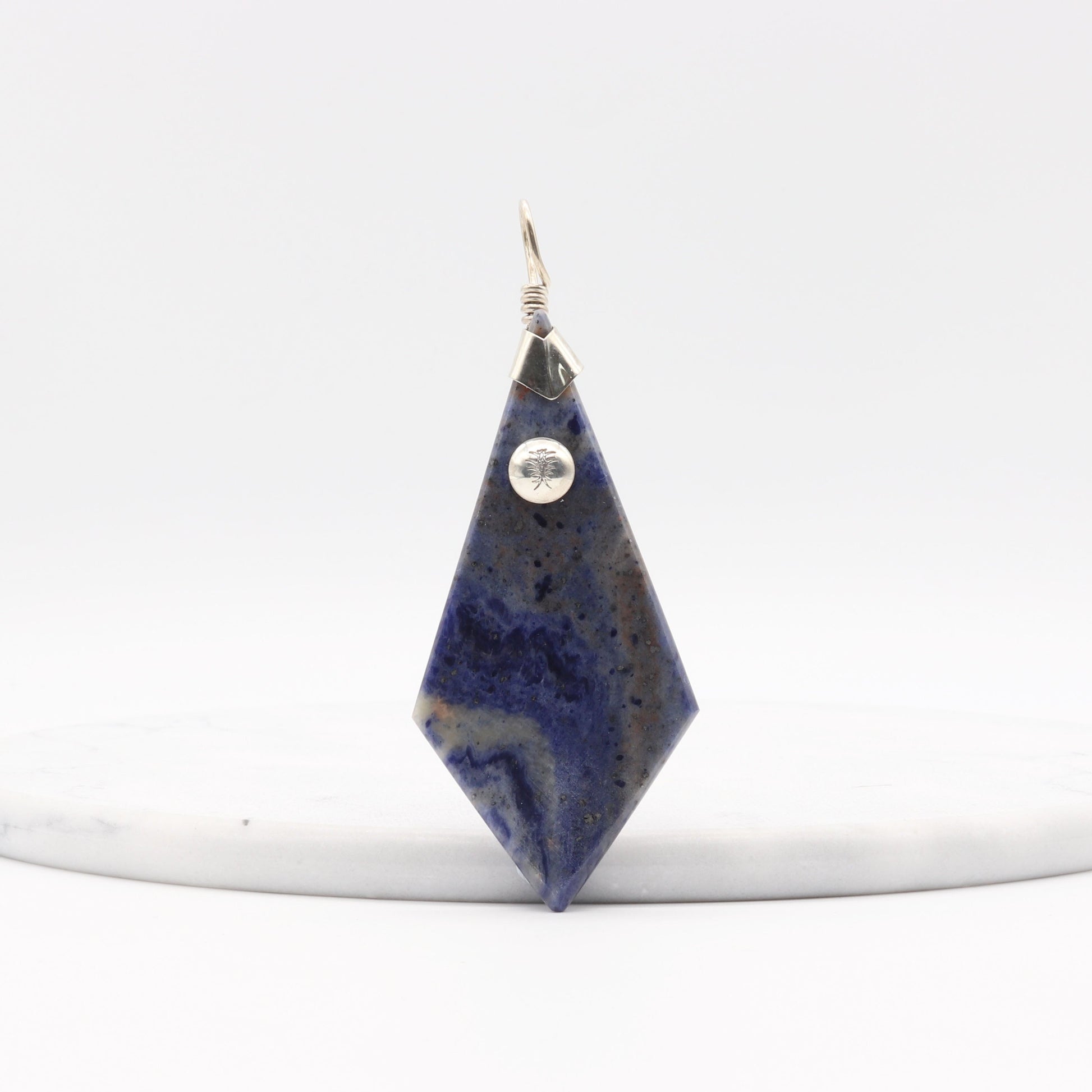 Blue Sodalite Pendant – Argentium® Silver Handmade on a white marble with a white background