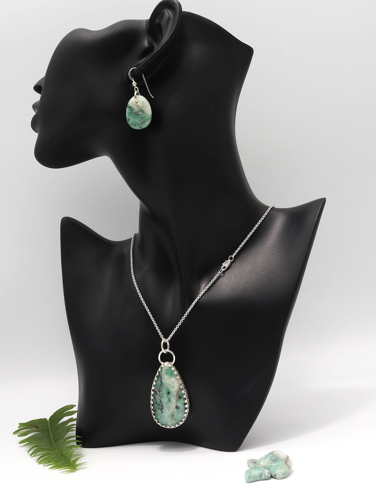 African Turquoise Jasper pendant necklace handcrafted in Argentium 935 silver shown with matching earrings available for purchase separately on a black resin model on a white background.