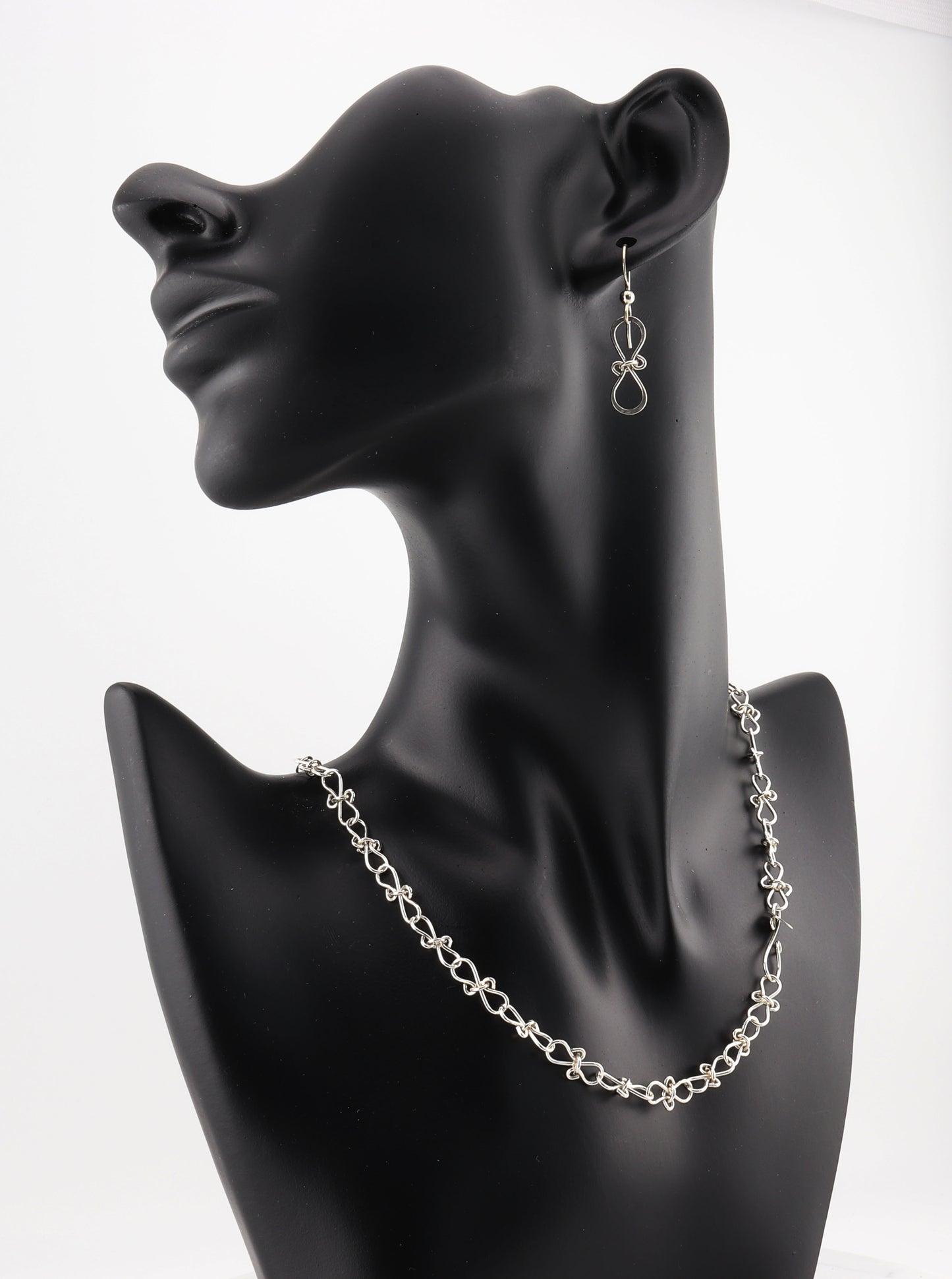 Handcrafted with care in our Missouri studio, this Infinity Bow Necklace by Elkhorn Silver™ is made from premium Argentium® 935 silver for a hypoallergenic, tarnish-resistant finish. Featuring intricate infinity bow shapes that symbolize eternal love and connection, this necklace is both meaningful and stylish.