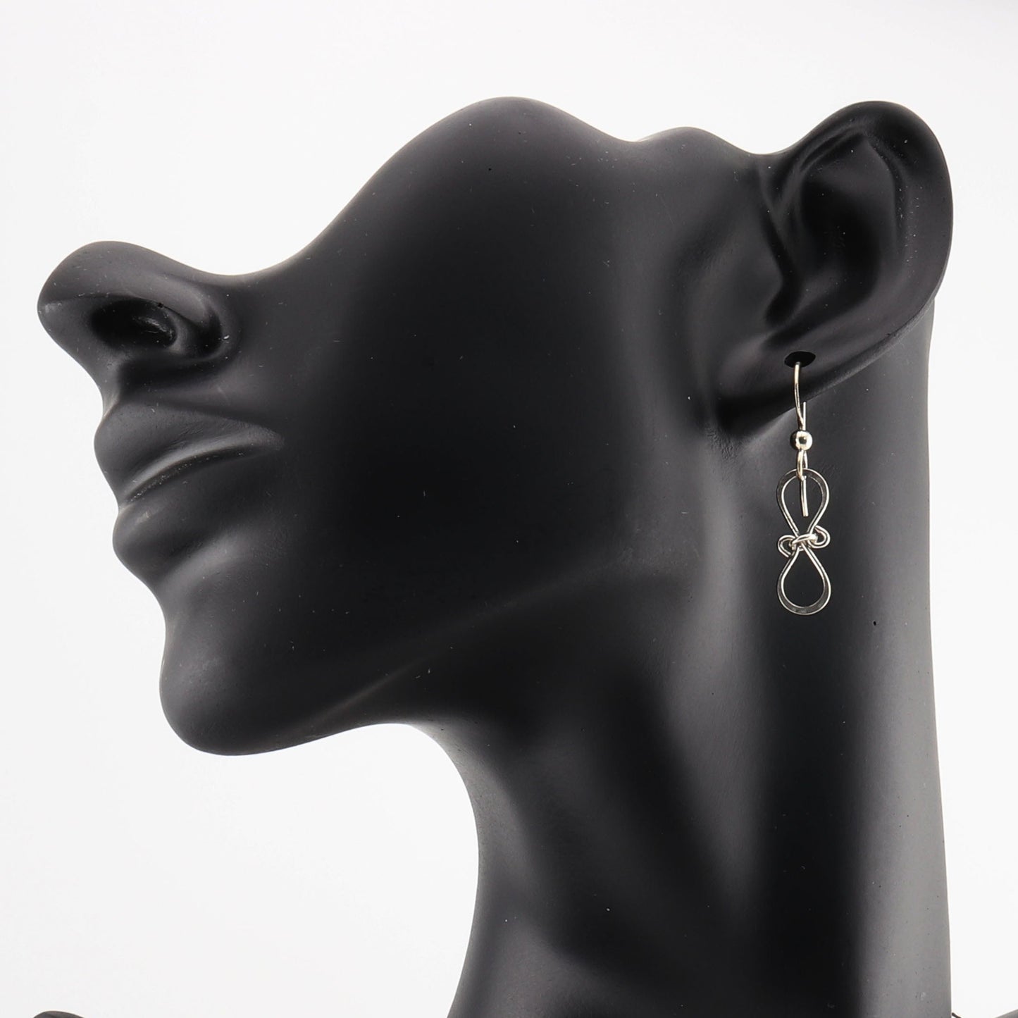 Elevate your jewelry collection with these stunning handcrafted Silver Bow Earrings, thoughtfully designed and created in the USA by Elkhorn Silver™. Made with premium 935 Argentium silver, these earrings feature a delicate hammered finish that shimmers beautifully in the light. Known for its hypoallergenic and tarnish-resistant properties, Argentium silver ensures these earrings are as durable as they are elegant.