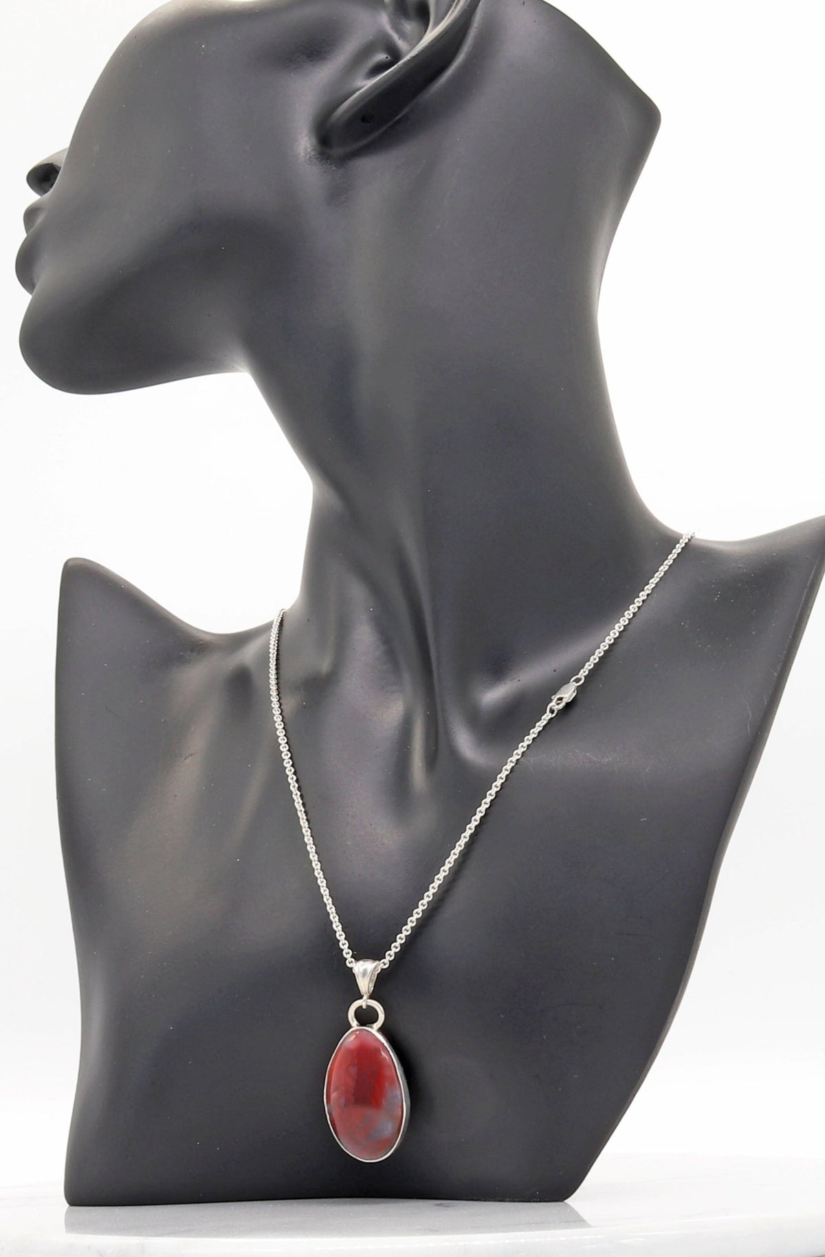 Handcrafted Petrified Rainbow Wood pendant necklace with Argentium 935 Silver bail and 18” chain, 41.48mm,   Displayed on black resin mannequin with text overlay Complete with Arizona Fossil and Silver Chain.