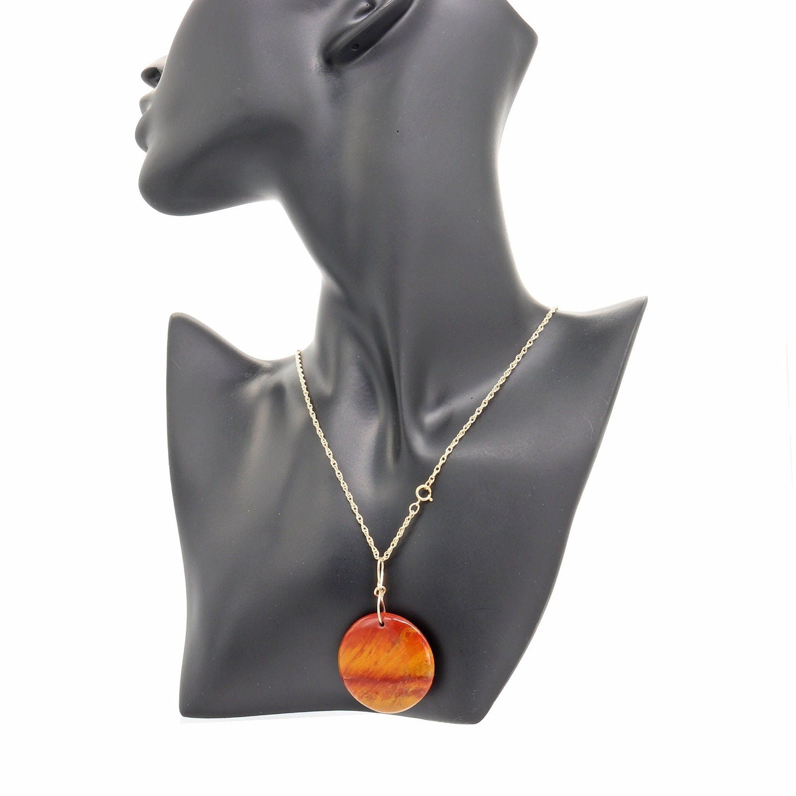 Capture attention with this 1.31 inch round Sonoran Sunrise Gemstone pendant, shown on black resin mannequin with chain not included.