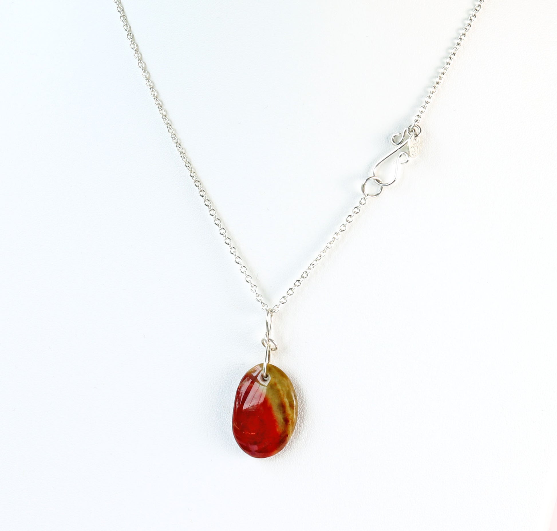 Necklace with a oval-shaped sonoran sunrise green and red pendant on a white background