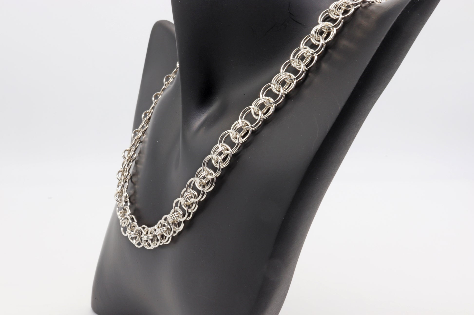 A handcrafted Helm Weave chain Necklace in solid sterling Argentium 935 Silver. Argentium silver is known for being tarnish resistant and hypoallergenic. The Helm weave design is  crafted with interlocking links, forming a captivating pattern resulting in a visually captivating design, perfect for any occasion or a gift. 18 or 19 inch.