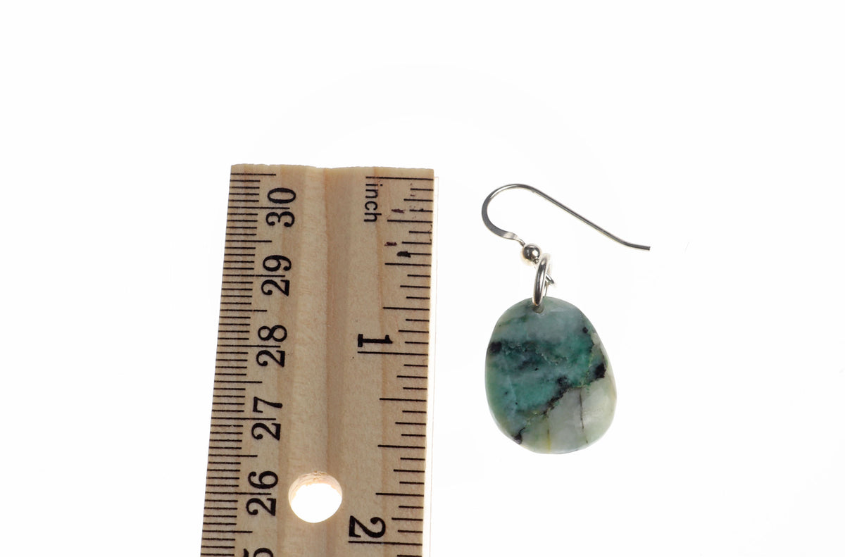 A single teardrop-shaped African turquoise jasper stone dangle earring with a silver fishhook ear wire, shown next to a wooden ruler for scale on a white background.