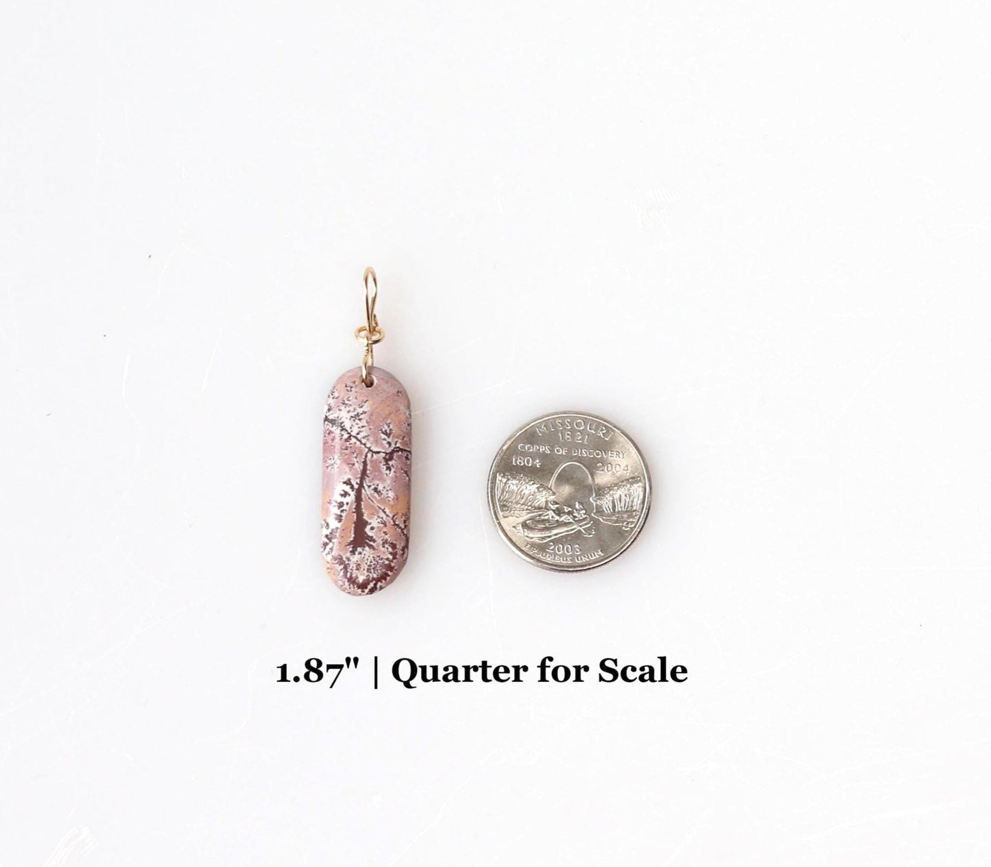 1.87 inch Sonoran Rhyolite  shown next to a Missouri quarter for scale on white background.