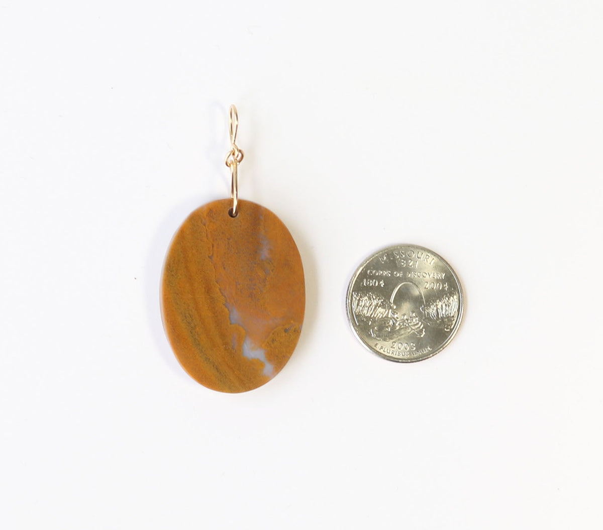 One-of-a-Kind Sonoran Sunrise Pendant – Hand-Cut in Missouri with warm golden ochre tones with soft white veining and natural crystal inclusions.  Shown next to Missouri state quarter for size scale on white background.
