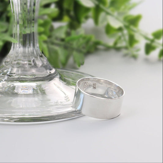 Wide 9 mm solid Argentium 935 silver ring with polished anticlastic band handcrafted by Elkhorn Silver