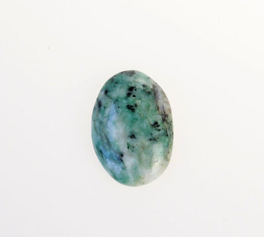 Hand-cut oval African Turquoise Jasper cabochon with  blue-green, teal, cream and black natural patterning on a white background.