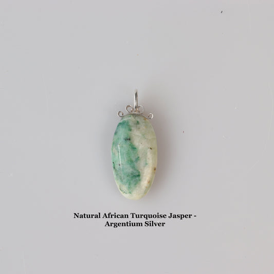 Oval African Turquoise Jasper Pendant – Handcrafted Focal Charm in Argentium Silver | Missouri-Made.  Shown against light gray background with text overlay Natural African Turquoise Jasper - Argentium Silver.