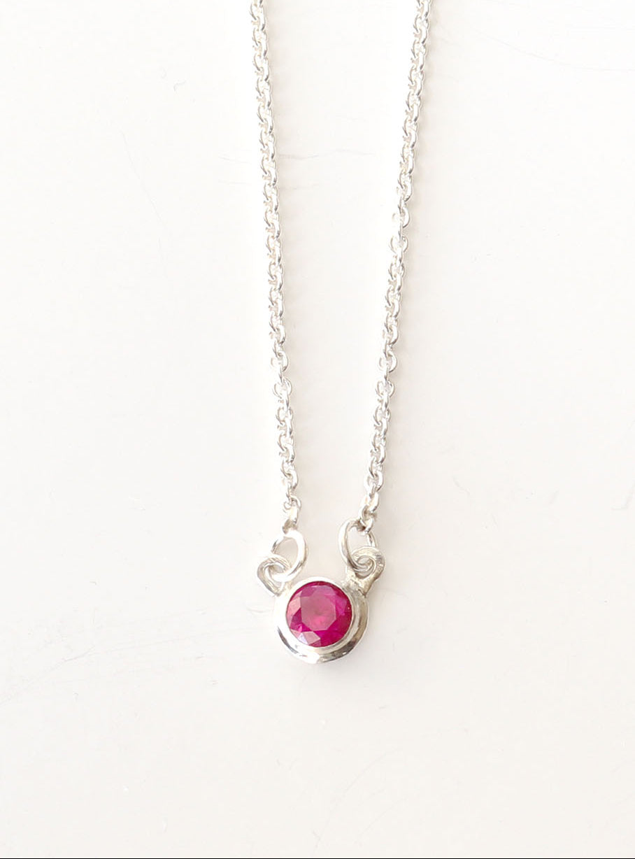 Argentium Necklace with a 5mm lab ruby red gemstone pendant on a white background