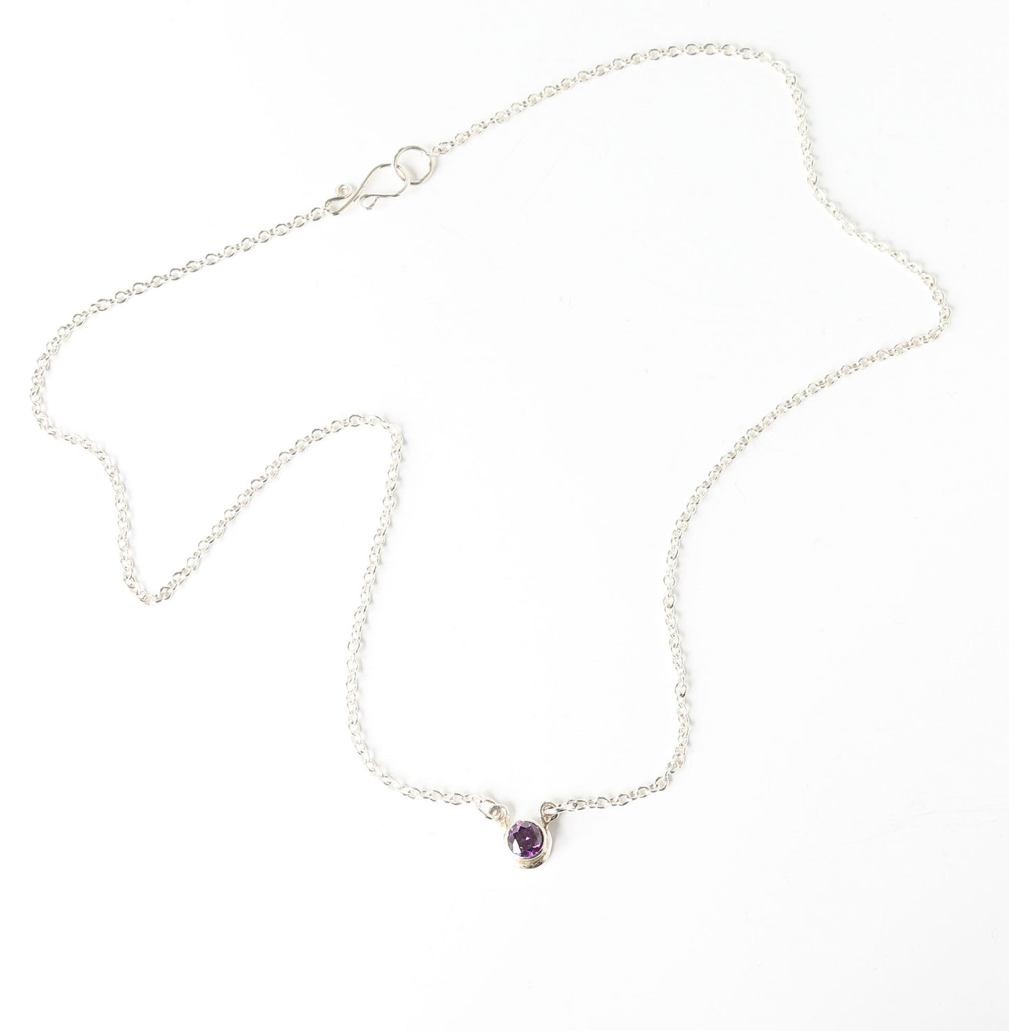 Argentium Silver necklace with a purple gemstone on a white background