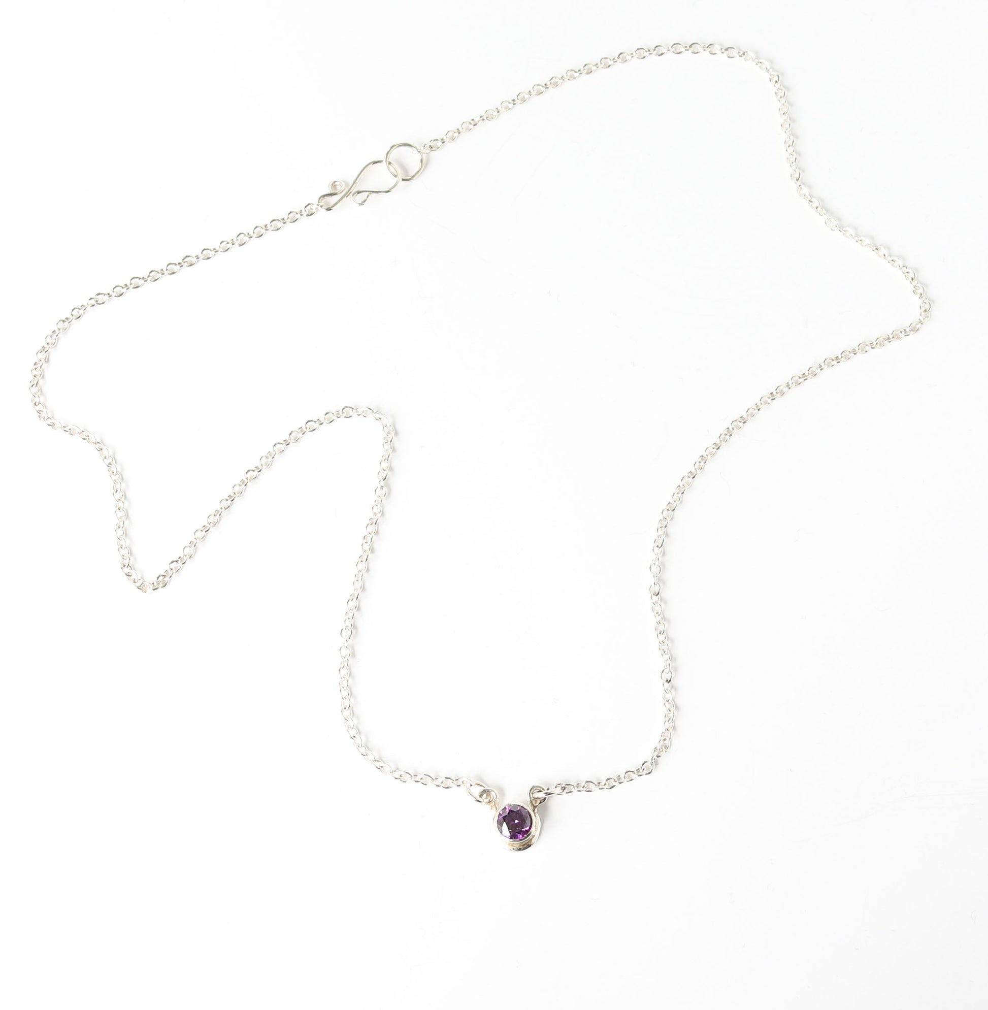 Argentium Silver necklace with a purple gemstone on a white background