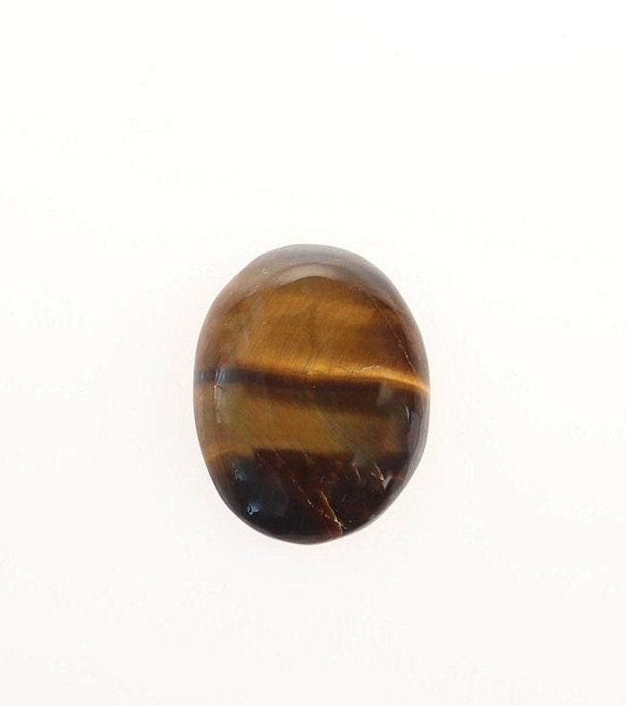 Front view of hand-cut natural Tiger's Eye cabochon showing golden-brown banding and chatoyancy on a white background.