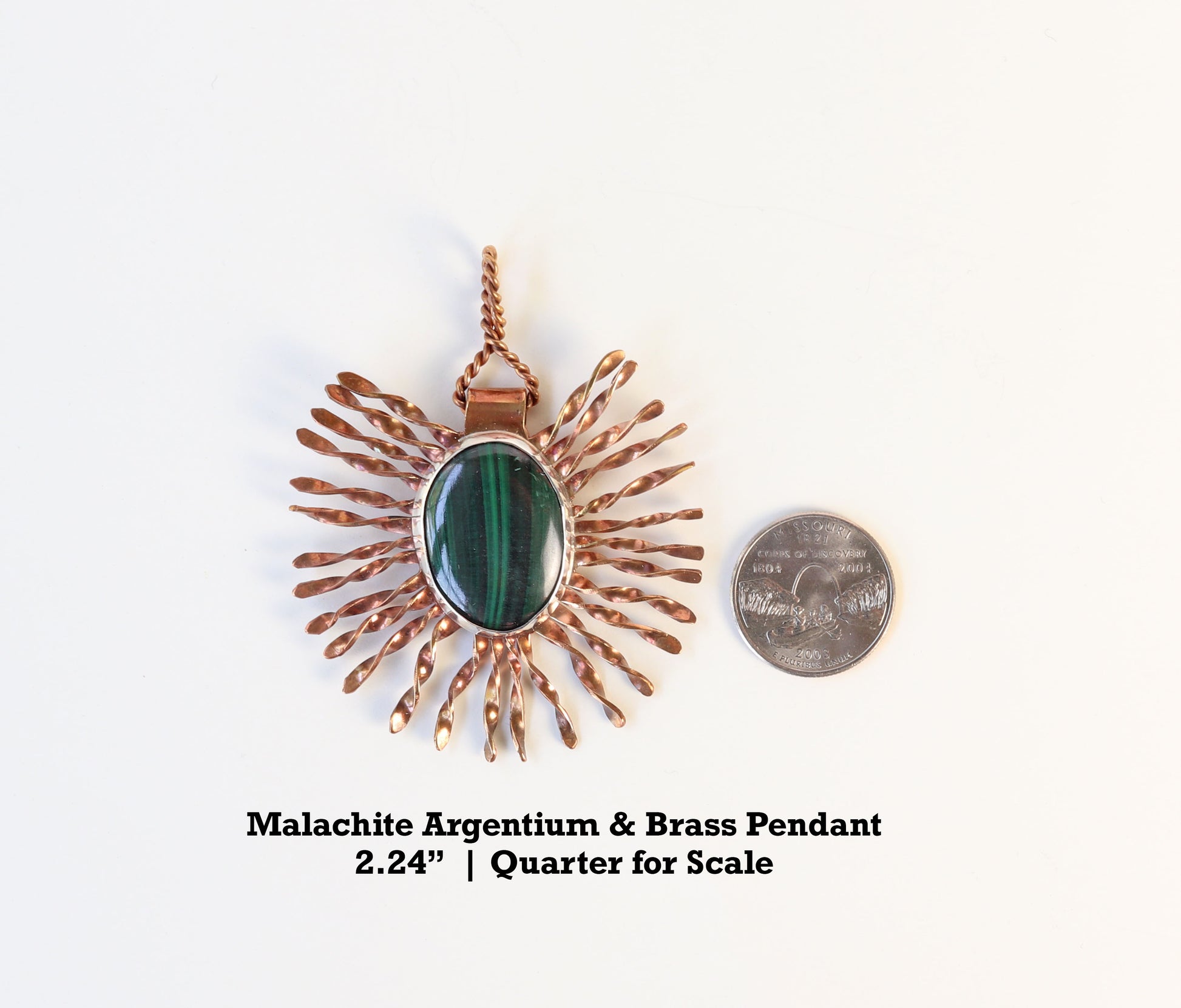 Malachite Starburst Pendant next to quarter to demonstrate size.  Text Overlay indicates Malachite Argentium & Brass Pendant 2.24 inch Quarter for Scale.